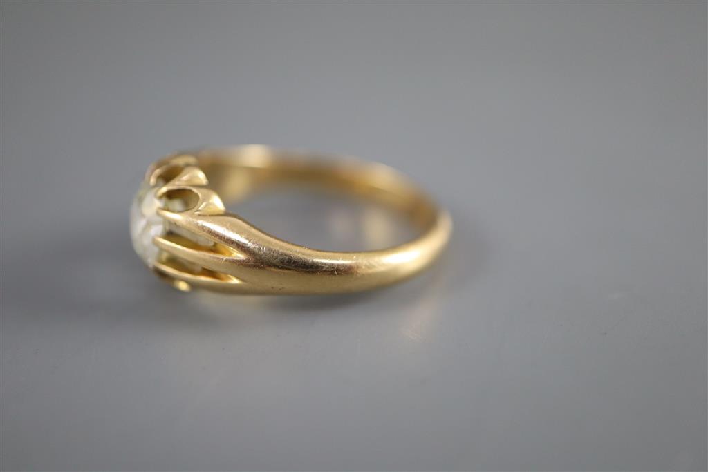 An early 20th century gold and old cushion cut claw set solitaire diamond ring, with fluted shoulders,
